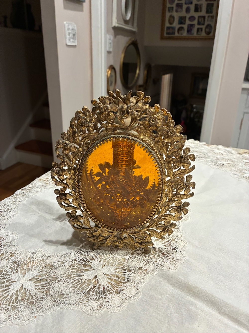 Vintage ormolu-style vanity perfume bottle featuring amber-toned glass